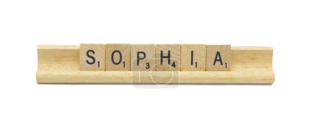 Miami, FL 4-18-24 popular baby girl first name of SOPHIA made with square wooden tile English alphabet letters with natural color and grain on a wood rack holder isolated on white background