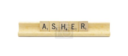 Miami, FL 4-18-24 popular baby boy first name of asher made with square wooden tile English alphabet letters with natural color and grain on a wood rack holder isolated on white background