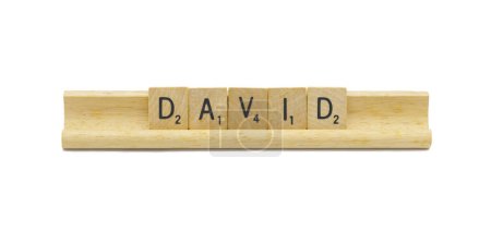 Miami, FL 4-18-24 popular baby boy first name of DAVID made with square wooden tile English alphabet letters with natural color and grain on a wood rack holder isolated on white background