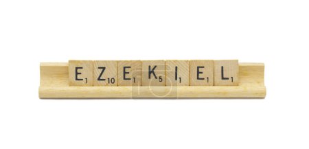 Miami, FL 4-18-24 popular baby boy first name of EZEKIEL made with square wooden tile English alphabet letters with natural color and grain on a wood rack holder isolated on white background