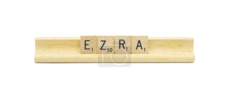 Miami, FL 4-18-24 popular baby boy first name of EZRA made with square wooden tile English alphabet letters with natural color and grain on a wood rack holder isolated on white background