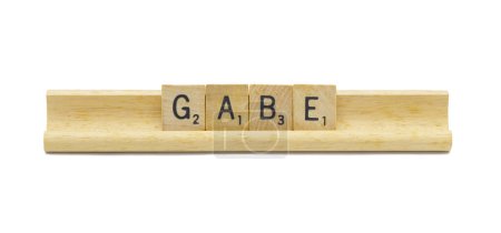 Miami, FL 4-18-24 popular baby boy first name of GABE made with square wooden tile English alphabet letters with natural color and grain on a wood rack holder isolated on white background