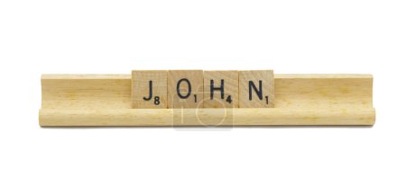Miami, FL 4-18-24 popular baby boy first name of JOHN made with square wooden tile English alphabet letters with natural color and grain on a wood rack holder isolated on white background