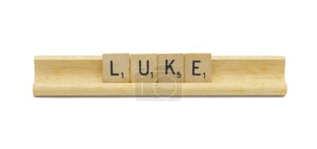 Miami, FL 4-18-24 popular baby boy first name of LUKE made with square wooden tile English alphabet letters with natural color and grain on a wood rack holder isolated on white background