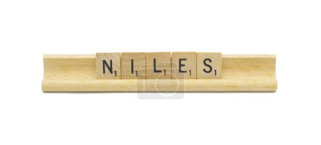 Miami, FL 4-18-24 popular baby boy first name of NILES made with square wooden tile English alphabet letters with natural color and grain on a wood rack holder isolated on white background