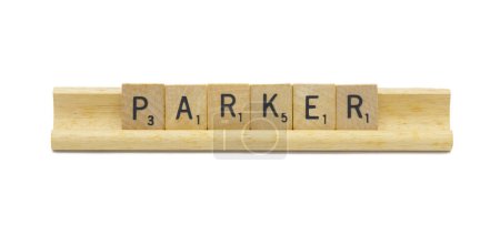 Miami, FL 4-18-24 popular baby boy first name of PARKER made with square wooden tile English alphabet letters with natural color and grain on a wood rack holder isolated on white background