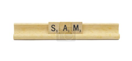 Miami, FL 4-18-24 popular baby boy first name of SAM made with square wooden tile English alphabet letters with natural color and grain on a wood rack holder isolated on white background