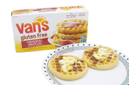Photo for Ocala, Florida 4-25-24 box of Vans gluten free original waffles baked with whole grain brown rice on an isolated background. Two waffles with butter and maple syrup on a white plate with edge design - Royalty Free Image