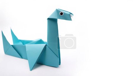 Photo for Monsters cryptid mythological creature concept origami of loch ness monster, isolated on white background with copy space side view, simple starter craft for kids - Royalty Free Image