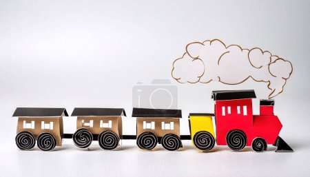 cute choo choo train toy train locomotive for kid, engine, wagon, wheels and railway, railroad conductor idea for a child.  concept paper origami isolated on light or white background with copy space
