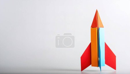 paper origami spaceship, rocket, space x ship, astrology concept isolated on white background with copy space, simple starter craft for kids for weekend arts and craft entertainment