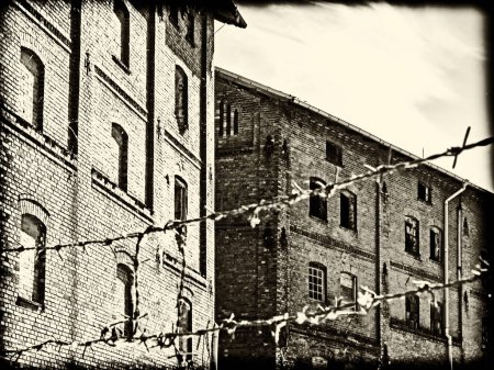Sepia-toned image of an old factory with a vintage look