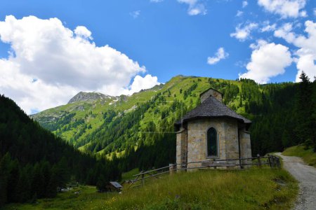 Photo for Hubertus chapel and High tauern mountains above in Austria - Royalty Free Image