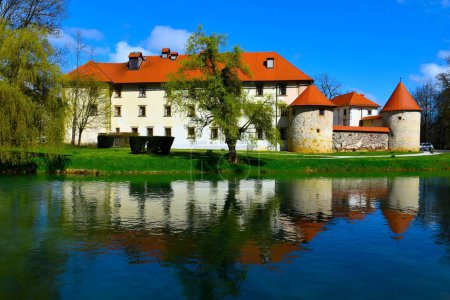 Photo for View of Otocec castle and a reflection of the castle in the water of Krka rive in Dolenjska, Slovenia - Royalty Free Image