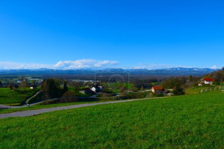 Village Ostrc bellow Gorjanci and hills in Dolenjska, Slovenia
