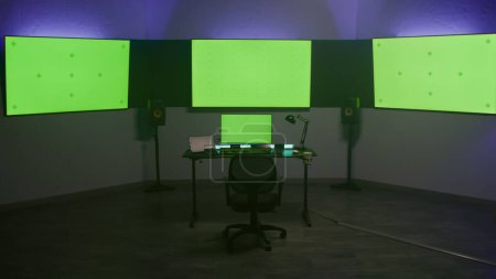Photo for Studio with modern equipment for video color correction. Computer, digital tablet and big screens showing program interface, video footage. Color grading control panel. Post production. Green screen. - Royalty Free Image