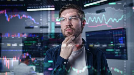 Male investment specialist analyzes cryptocurrency charts in modern office. 3D render of real-time stocks on glass wall. Futuristic AI VFX animation. Computers and big digital screens on background.