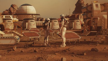 Foto de Dos astronautas en trajes espaciales caminan hacia la estación de investigación, colonia o base científica en Marte. Celda solar y paneles. Misión espacial en el planeta rojo. Concepto de colonización futurista y exploración espacial. - Imagen libre de derechos