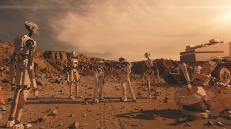 Foto de Dos astronautas en trajes espaciales hablan, parados en la superficie de Marte con robots. AI impulsado rover en el fondo. Misión espacial tripulada explorando. Planeta rojo. Concepto de colonización y exploración futurista. - Imagen libre de derechos