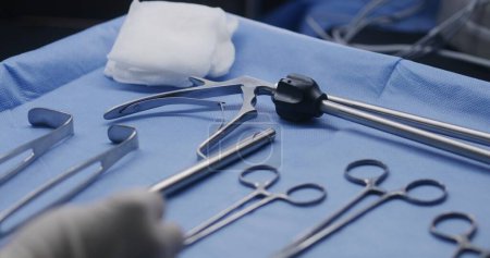 Close up shot of table with professional surgical instruments in surgery. Medical personnel do heart transplantation to seriously ill patient in operating room. Medics work in modern medical facility.