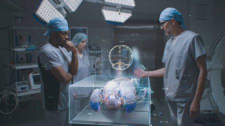 Photo for Multiethnic surgeons work in hospital operating room. 3D graphics of virtual hologram showing human skeleton, brain and vital signs. VFX animation. AI technologies in medicine. Futuristic healthcare. - Royalty Free Image