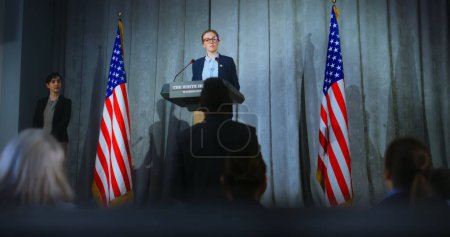 Photo for US presidential candidate makes an announcement, answers media questions, gives interview. Female American republican politician during performance at press conference. Backdrop with American flags. - Royalty Free Image
