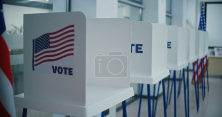 Photo for National Election Day in the United States of America. Voting booths with American flag logo in bright polling station office. Political races of US presidential candidates. Concept of democracy. - Royalty Free Image