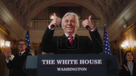 Senior American minister or government representative gestures and poses on cameras for media and television. US President finishes political speech at press conference in the White House. Slow motion
