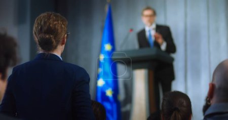 Female representative of media asks question to European politician performing at press conference. Confident EU consul makes an announcement, delivers campaign speech, gives interview. Election day.