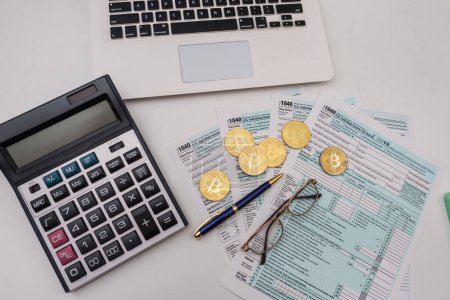 Photo for Form 1040 with pen bitcoin coins calculator financial document. Paperwork. tax forms submission of citizens' taxes - Royalty Free Image