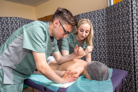 Photo for Young woman getting four hands back massage in beauty spa for body wellness. spa salon massage therapists. body beauty - Royalty Free Image