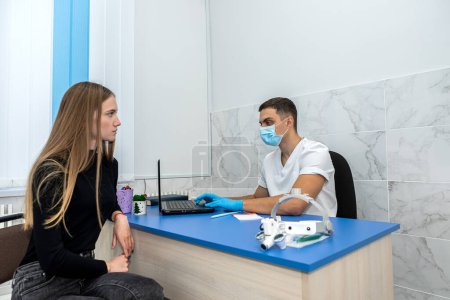 Photo for Beautiful young girl came to an appointment with a ENT doctor with an earache. the concept of a patient at the reception. a girl at a doctor's appointment - Royalty Free Image