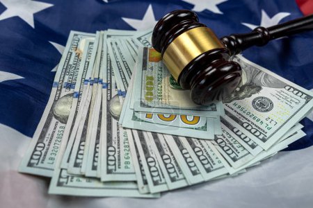 Photo for Hundred dollar bills and a judge's gavel placed on an American flag. isolated Justice in the country. Bribery and bribery of the authorities - Royalty Free Image