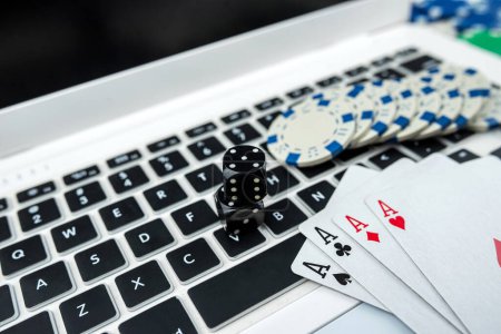 Photo for Online poker with laptop playing card chips and dice. Online gambling casino concept - Royalty Free Image