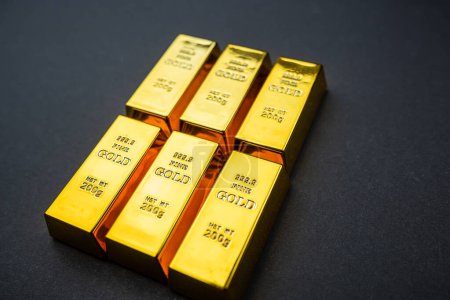 Stack of golden bars isolated on black background. Financial  investment and wealth concept.