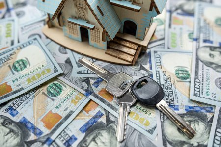 Photo for Little house model with many dollar banknotes and  keys. Real estate insurance. Investment - Royalty Free Image