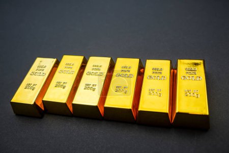 Gold bars isolated on black background. Finance and saving value concept