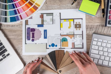 Photo for Female designer at creative work with blueprints and color set samples, decoration and renovation. Apartment sketch - Royalty Free Image