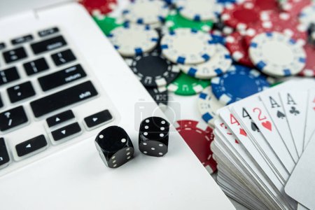 Online-Poker mit Laptop-Spielkartenchips und Würfeln. Online Glücksspiel Casino Konzept