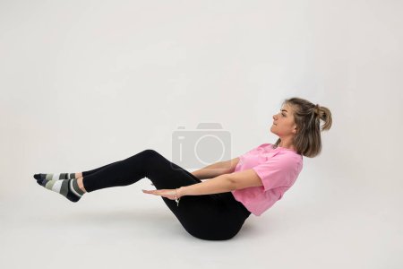 Sportliche junge Frau macht entspanntes Yoga auf weißem Hintergrund. Gesunder Lebensstil