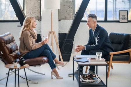 Photo for Conversation. A man and a woman in the office having a conversation - Royalty Free Image