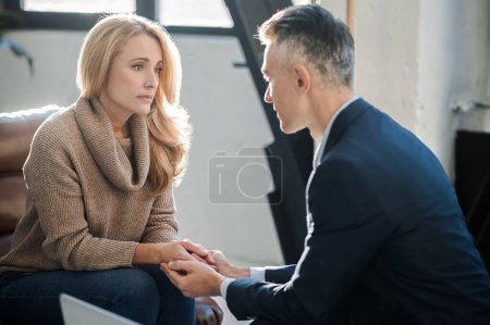 Photo for Psychological problems. Blonde woman having an appointment at the mental physician - Royalty Free Image