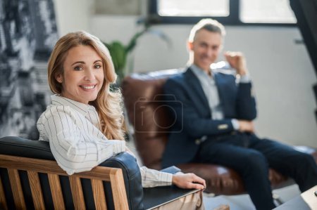Photo for Appointment. Blonde woman talking to a man at her office - Royalty Free Image