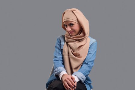 Photo for Cute young woman. Young woman in beige hijab looking cute and smiling - Royalty Free Image