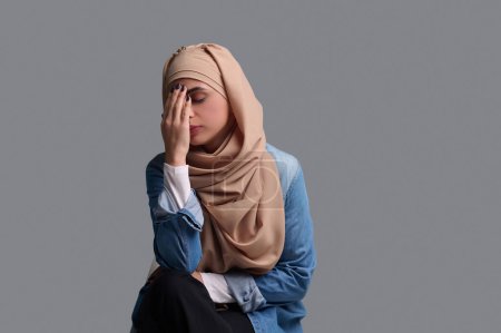 Photo for Woman in stress. Young muslim woman feeling stressed and upset - Royalty Free Image