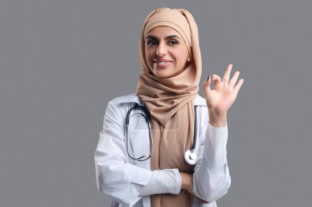 Téléchargez les photos : Une femme heureuse. Jeune femme musulmane dans le hijab à la recherche satisfait et heureux - en image libre de droit