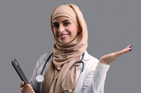 Photo for Doctor. Smiling young female doctor in hijab - Royalty Free Image