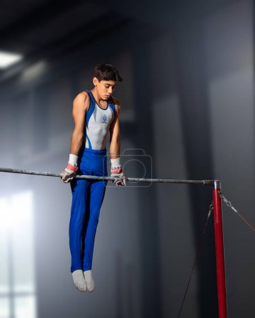Photo for Queretaro, Queretaro, 11 18 22, young hispanic man practicing aerobic gymnastics in gym during the summer - Royalty Free Image