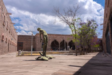 Photo for San luis potosi, san luis potosi, 23 04 08, Outdoor secondary courtyard, stone architecture with statue at the center of a naked man looking up at the sky inside the Leonora Carrington Museum, no people - Royalty Free Image