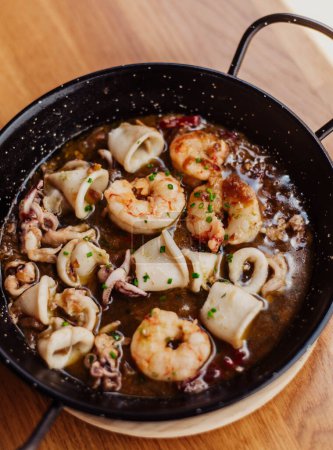 Photo for Squid and garlic prawns portion in a tapas bar - Royalty Free Image